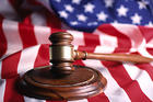 Photo of a gavel on an American flag.